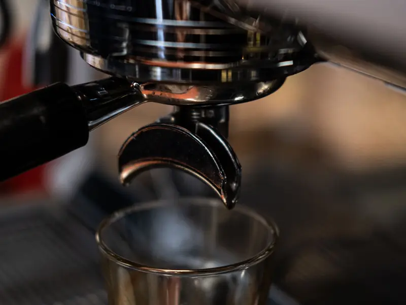 Espresso brewing into a glass